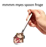 a hand is holding a spoon with a picture of a girl on it and the caption mmmm myes spoon froge