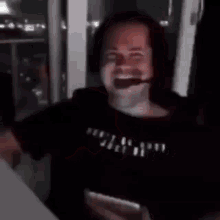a man wearing headphones pointing at the camera