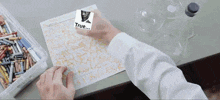 a person holding a piece of paper that says true