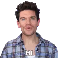 a man wearing a plaid shirt is saying hi