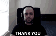 a man wearing headphones and a microphone says thank you