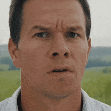 a close up of a man 's face making a funny face