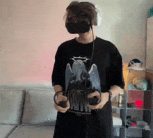 a man wearing a virtual reality headset and headphones is holding a controller .