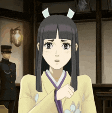 a woman in a yellow kimono with a purple ribbon around her neck looks surprised