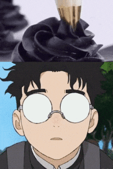 a man wearing glasses is looking at a cupcake with black frosting