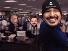 a man wearing a dex screener beanie smiles in front of a crowd