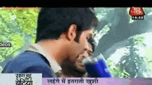 a tv screen shows a man talking to another man in a foreign language