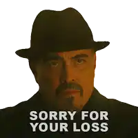 a man wearing a hat and a suit says sorry for your loss