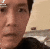 a close up of a person 's face with a blurred background .