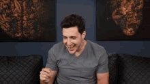a man wearing a grey scrub top that says dm on the front