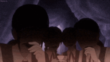 a group of people sitting in a dark room with a purple background