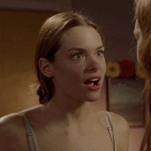 a woman with a surprised look on her face is talking to another woman