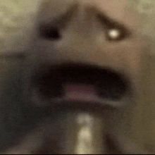 a close up of a person 's face with their mouth open and a light coming out of it .
