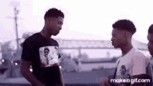 a group of young men are standing next to each other on a bridge .