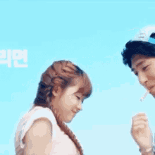 a man and woman are kissing in front of a blue background