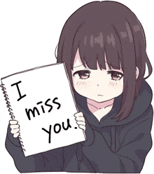 a girl is holding a piece of paper with the words `` i miss you '' written on it .