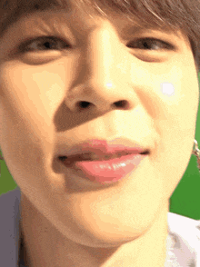 a close up of a man 's face with a green background .