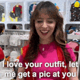 a woman in a pink shirt and red vest says i love your outfit let me get a pic at you