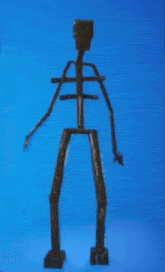 a statue of a skeleton against a blue sky