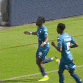 a soccer player is running on the field with a soccer ball .