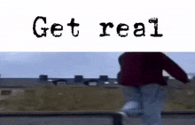 a person is riding a skateboard on a railing with the words `` get real '' written on it .