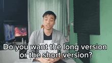a man sitting at a desk with the words " do you want the long version or the short version "