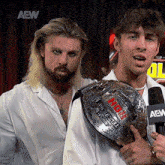 two men standing next to each other with the word aew on the bottom right