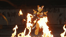 a person in a costume stands in front of a fire