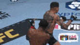a fighter with a tattoo on his back throws a punch at another fighter