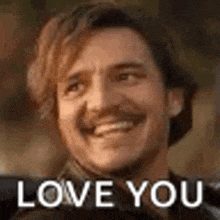 a man with a beard and mustache is smiling and saying `` i love you '' .