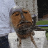 a statue of a man with a beard and a mask on