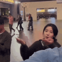 a group of people are standing in a room with a sign that says ' a '