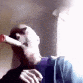 a man is drinking a bottle of coca cola from a straw