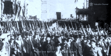 a black and white photo of a crowd with the words and the battle going again
