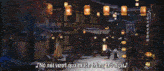 a man and woman are walking down a street with lanterns in the background
