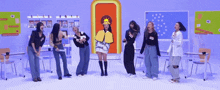 a group of women are dancing in a classroom with a woman wearing a hat that says sun