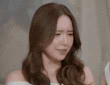 a close up of a woman 's face with a sad look on her face