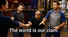 a group of men standing in a room with the words " the world is our clam "