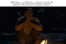 a man sits in a dark room with the words " this edible ain 't shi " above him