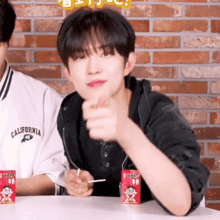 a man wearing a california shirt is pointing