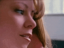 a close up of a woman 's face while talking on a phone .