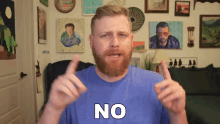 a man in a blue shirt says no with his hands