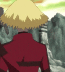 a cartoon character wearing a red jacket and a yellow hat is standing in front of a mountain .