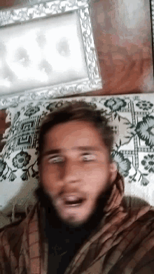 a man is laying on a rug with a picture frame in the background