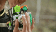 a person is holding a toy that has a green button that says ' samurai ' on it