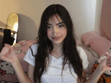 a girl wearing a white shirt with a heart shaped necklace