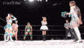 a group of women wrestling in a ring with the word stardom in the background
