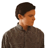 a young man in a denim shirt looks to his left