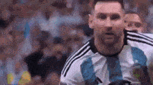 a close up of a soccer player wearing a blue and white jersey