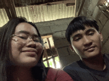 a boy and a girl are posing for a picture
